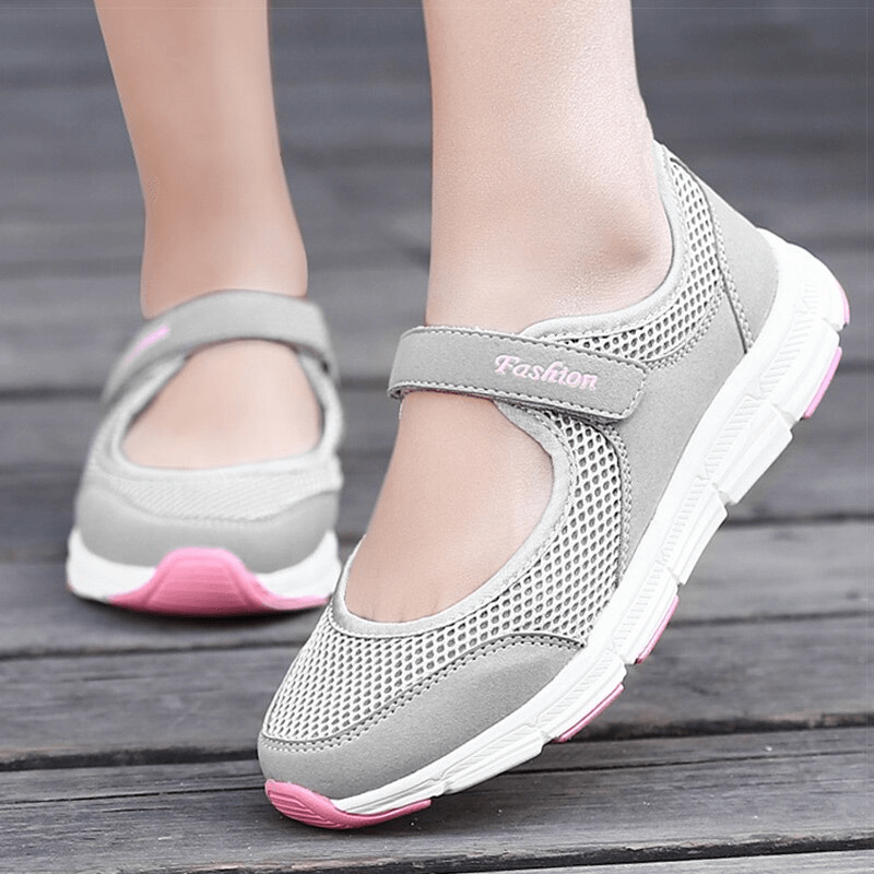 Women's breathable vulcanized flat shoes in gray with pink accents, featuring air mesh material and hook and loop closure.